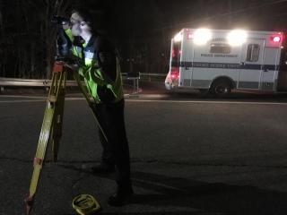 Officer Lettieri assisting with laser mapping an accident investigation